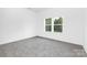 Cozy bedroom with a large window showcasing scenic outdoor views and plush carpeting at 24578 Blue Heron Cir # 407, Lancaster, SC 29720
