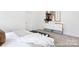 Bedroom featuring neutral bedding, a large dresser, and minimalist decor at 24578 Blue Heron Cir # 407, Lancaster, SC 29720