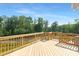 Expansive wood deck offering stunning views of lush greenery and a serene sky at 24578 Blue Heron Cir # 407, Lancaster, SC 29720