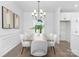 Bright dining area with a stylish chandelier, modern decor, and views of the well manicured lawn at 24578 Blue Heron Cir # 407, Lancaster, SC 29720