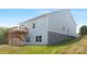 Exterior of a home featuring stone accents, light blue siding, a wooden deck with stairs, and well-kept green grass at 24578 Blue Heron Cir # 407, Lancaster, SC 29720