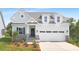 Charming two-story home featuring light blue siding, stone accents, and a welcoming front porch at 24578 Blue Heron Cir # 407, Lancaster, SC 29720