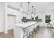 Modern kitchen featuring white cabinets, a large island with seating, and stainless steel appliances at 24578 Blue Heron Cir # 407, Lancaster, SC 29720