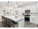 Kitchen showcases white cabinets, stainless steel appliances, and a spacious island with seating at 24578 Blue Heron Cir # 407, Lancaster, SC 29720