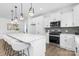 Bright kitchen with white cabinetry, stainless steel appliances, and a large island with bar seating at 24578 Blue Heron Cir # 407, Lancaster, SC 29720