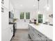 Kitchen with white cabinets, modern appliances, and a large island overlooking living spaces at 24578 Blue Heron Cir # 407, Lancaster, SC 29720