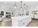Open-concept living space with kitchen island, adjoining living room, and dining area, perfect for entertaining at 24578 Blue Heron Cir # 407, Lancaster, SC 29720