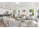 Bright living room with modern furniture and decor, open to a kitchen with a large island at 24578 Blue Heron Cir # 407, Lancaster, SC 29720