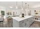 Open-concept area includes a long kitchen island overlooking a dining and living room space at 24578 Blue Heron Cir # 407, Lancaster, SC 29720