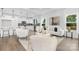 Open concept living room and kitchen with hardwood floors, modern appliances, and bright windows at 24578 Blue Heron Cir # 407, Lancaster, SC 29720
