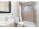 A bright bathroom featuring a pedestal sink, standard toilet, and a shower with framed window at 2607 Vail Ave, Charlotte, NC 28207
