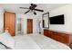 A well-lit bedroom featuring a plush bed, ceiling fan, wooden dresser, and closet space for ample storage at 2607 Vail Ave, Charlotte, NC 28207