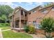 Brick apartment building rear view with wooden deck, porch, and lush landscaping adding to the property's appeal at 2607 Vail Ave, Charlotte, NC 28207