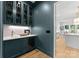 Stylish bar area featuring custom cabinetry, a wine fridge, and a sink, perfect for entertaining guests at 2921 Windsor Ave, Charlotte, NC 28209