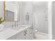 Elegant bathroom featuring a marble vanity, gold mirror, and a sleek glass-enclosed shower at 2921 Windsor Ave, Charlotte, NC 28209