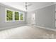 Bright bedroom with plush carpet, neutral walls, and a view of the green landscape at 2921 Windsor Ave, Charlotte, NC 28209