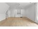 Spacious bonus room features an entertainment center with a refrigerator, white cabinets, and hardwood flooring at 2921 Windsor Ave, Charlotte, NC 28209