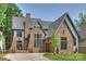 Charming brick home features a well-manicured lawn and an attached garage at 2921 Windsor Ave, Charlotte, NC 28209