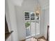 Bright foyer featuring a large window and a stylish chandelier, complemented by hardwood flooring at 2921 Windsor Ave, Charlotte, NC 28209