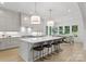 Spacious kitchen featuring a large island with seating, modern pendant lights, and plenty of counter space at 2921 Windsor Ave, Charlotte, NC 28209
