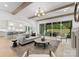 Cozy living room flowing into modern kitchen featuring a fireplace and open floor plan at 2921 Windsor Ave, Charlotte, NC 28209