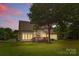 View of the house featuring a wooden deck and a spacious yard with lush trees at 3213 Strawberry Rd, Matthews, NC 28104