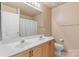 Traditional bathroom with dual sinks, and a large mirror at 3213 Strawberry Rd, Matthews, NC 28104