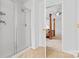Bright bathroom featuring a glass door shower and partial view to main bedroom at 3213 Strawberry Rd, Matthews, NC 28104