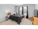 Cozy bedroom with neutral carpet, window and black bedding at 3213 Strawberry Rd, Matthews, NC 28104