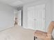 Bedroom with neutral walls, white closet doors, and carpet at 3213 Strawberry Rd, Matthews, NC 28104