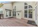 A house featuring a wooden deck with many large windows and a door that allows access to the backyard at 3213 Strawberry Rd, Matthews, NC 28104