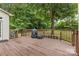 Wooden deck featuring wood railings that offers a scenic view of the surrounding lush greenery at 3213 Strawberry Rd, Matthews, NC 28104