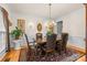 Elegant dining room with hardwood floors, wainscoting, chandelier and traditional decor at 3213 Strawberry Rd, Matthews, NC 28104
