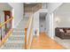 Inviting entryway featuring hardwood floors, a staircase with wood railings, and neutral wall colors at 3213 Strawberry Rd, Matthews, NC 28104