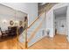 Elegant entryway with hardwood floors, staircase, and views into dining area with chandelier at 3213 Strawberry Rd, Matthews, NC 28104