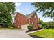 A large brick home features a 2-car garage, basketball hoop, and well-maintained landscaping at 3213 Strawberry Rd, Matthews, NC 28104