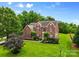Charming brick home with lush green lawn and manicured landscaping, offering a welcoming curb appeal at 3213 Strawberry Rd, Matthews, NC 28104