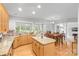 Spacious eat-in kitchen featuring an island, natural light, and an adjacent formal dining area at 3213 Strawberry Rd, Matthews, NC 28104