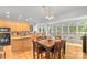Bright kitchen featuring a wooden island, backsplash, and an adjacent dining area with large windows at 3213 Strawberry Rd, Matthews, NC 28104
