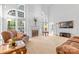 Bright living room features a fireplace, soaring windows, and ample seating, creating an inviting atmosphere at 3213 Strawberry Rd, Matthews, NC 28104