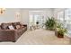 Bright living room featuring a cozy sofa, bay windows, and ample natural light at 3213 Strawberry Rd, Matthews, NC 28104