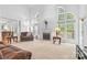 Bright living room featuring high ceilings, large windows, and a cozy fireplace at 3213 Strawberry Rd, Matthews, NC 28104
