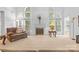 Spacious living room featuring soaring windows, a fireplace, and comfortable seating at 3213 Strawberry Rd, Matthews, NC 28104
