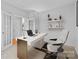 Home office featuring a modern white desk, a comfortable chair, and ample natural light at 3213 Strawberry Rd, Matthews, NC 28104