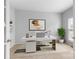 Bright office features a modern white desk, neutral decor and an abundance of natural light at 3213 Strawberry Rd, Matthews, NC 28104