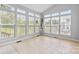Sunroom filled with natural light, tile flooring, and an indoor plant feature at 3213 Strawberry Rd, Matthews, NC 28104
