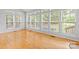 Bright sunroom with hardwood floors and large windows providing natural light and outdoor views at 3213 Strawberry Rd, Matthews, NC 28104