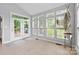 Bright sunroom features large windows, tiled floors, and access to the outdoor deck at 3213 Strawberry Rd, Matthews, NC 28104