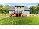 Spacious backyard with a deck, lush green grass, and a fenced-in perimeter at 328 Pamela St, Gastonia, NC 28054