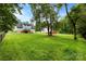 Expansive backyard with a deck, lush lawn, mature trees, and a secure fence at 328 Pamela St, Gastonia, NC 28054